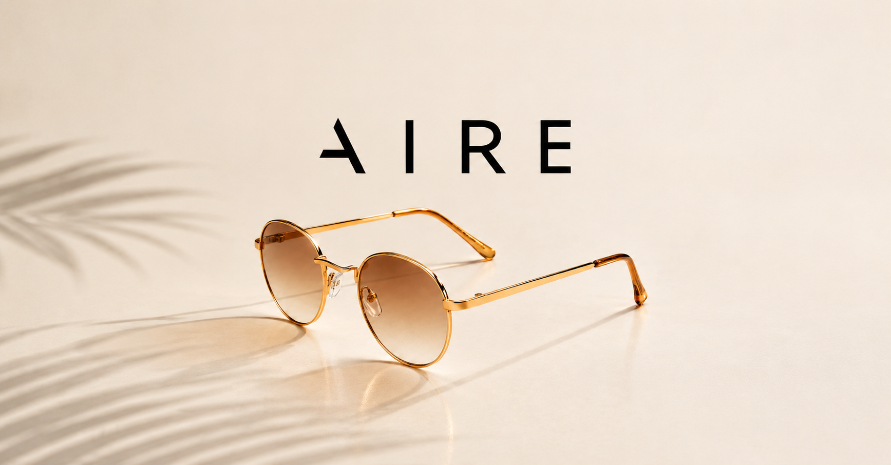 AIRE round gold frame sunglasses displayed on a neutral background with soft shadows.