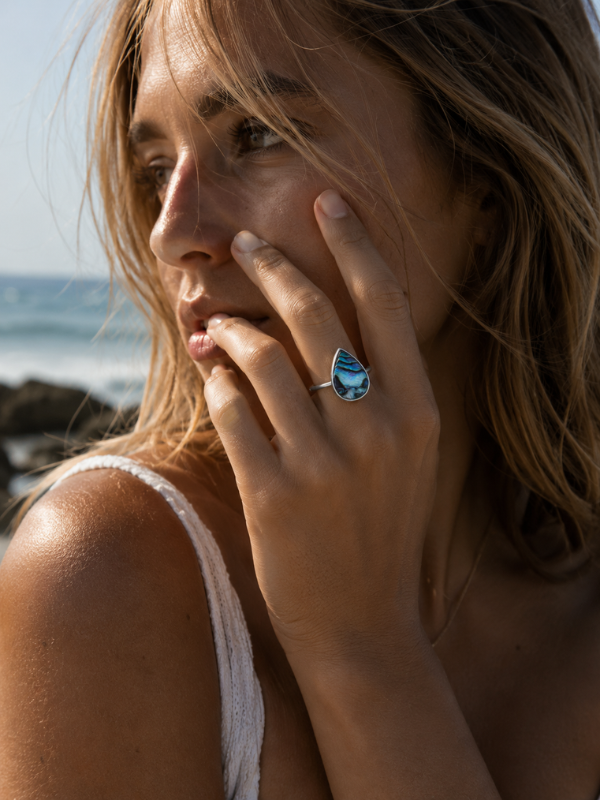 Handmade 925 sterling silver ring featuring a large teardrop-shaped abalone shell with natural iridescent colouring.