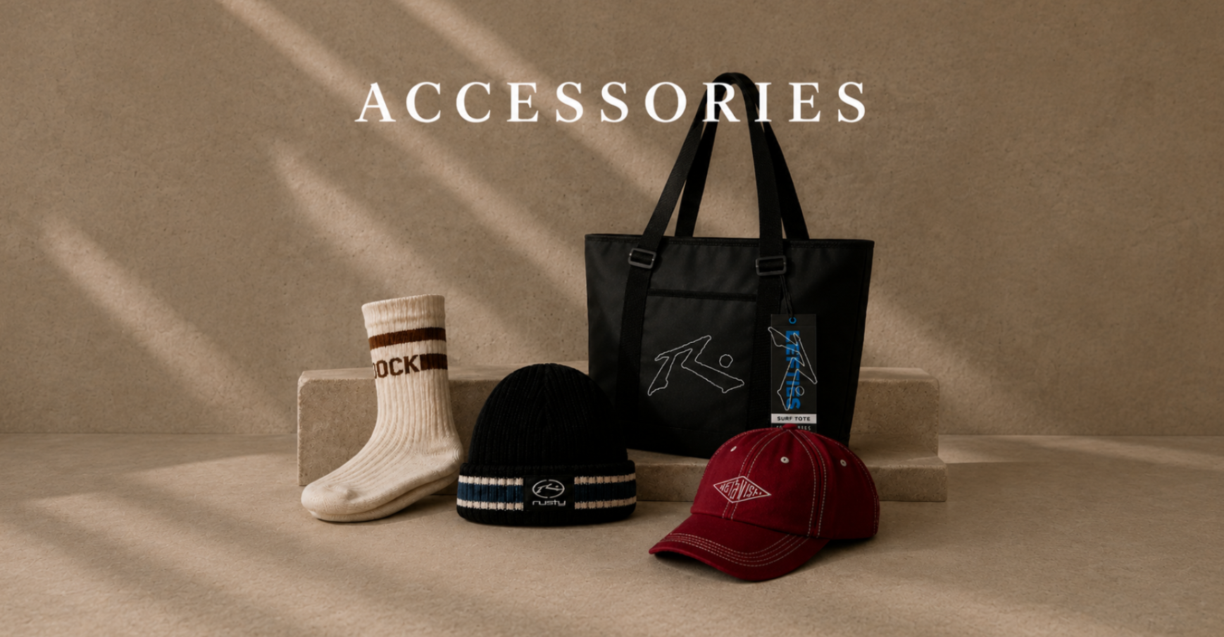 Men's accessories collection featuring a tote bag, beanie, cap and socks on a neutral studio background.