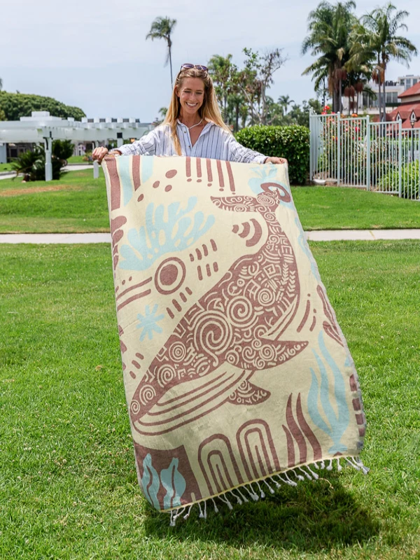 Sand Cloud Moby The Whale organic cotton beach towel featuring a coastal whale design.