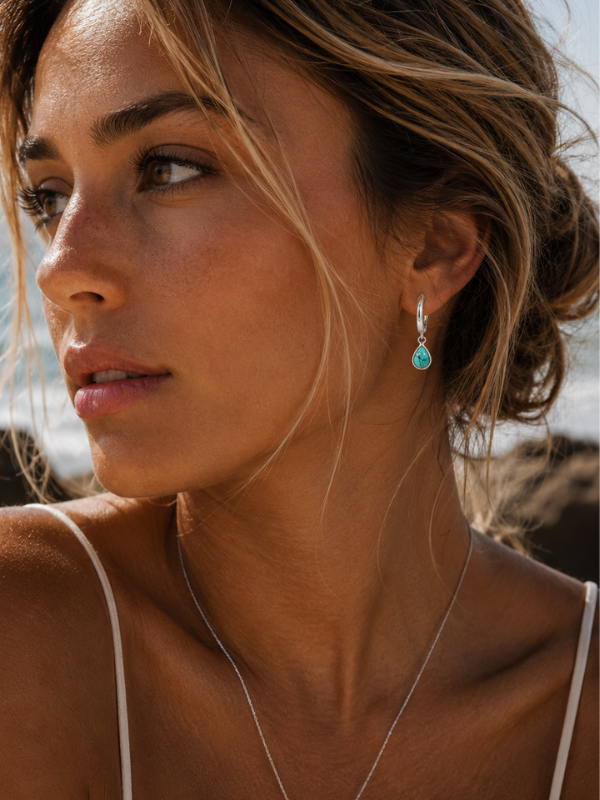 925 sterling silver huggie earrings featuring teardrop-shaped turquoise stone with unique natural colouring and pattern.