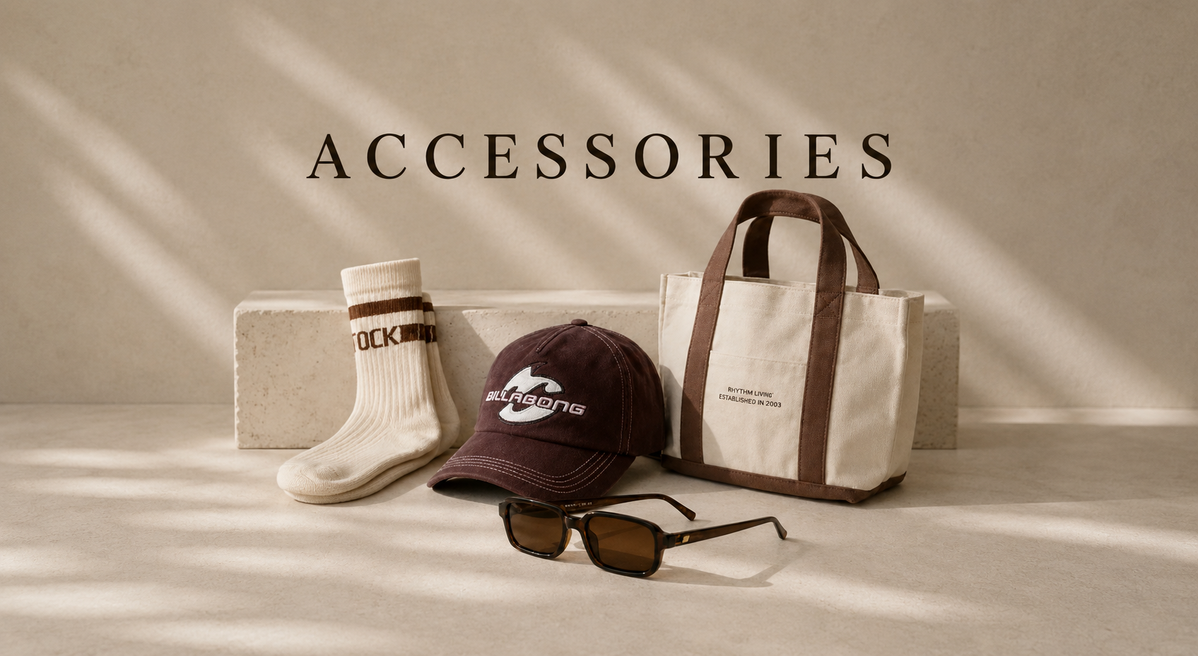 Women's accessories collection featuring a tote bag, cap, sunglasses and socks on a neutral background.